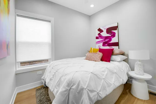 a bedroom with a bed and a window