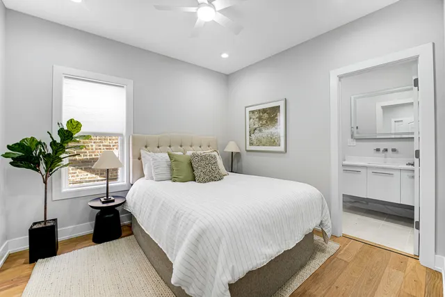a bedroom with a large bed and a chandelier