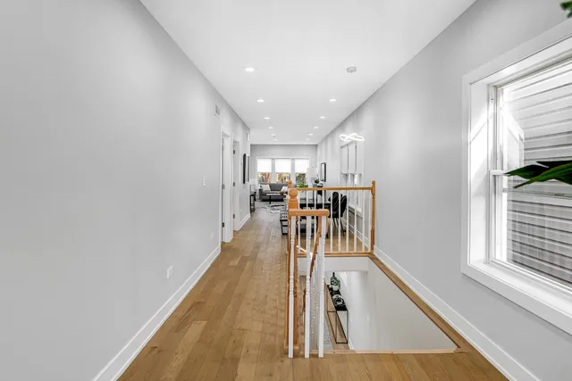a view of a dining room with furniture a chandelier and wooden floor