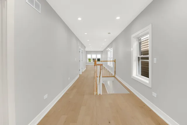 a view of entryway and hall with wooden floor