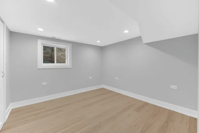 a view of a room with wooden floor and window