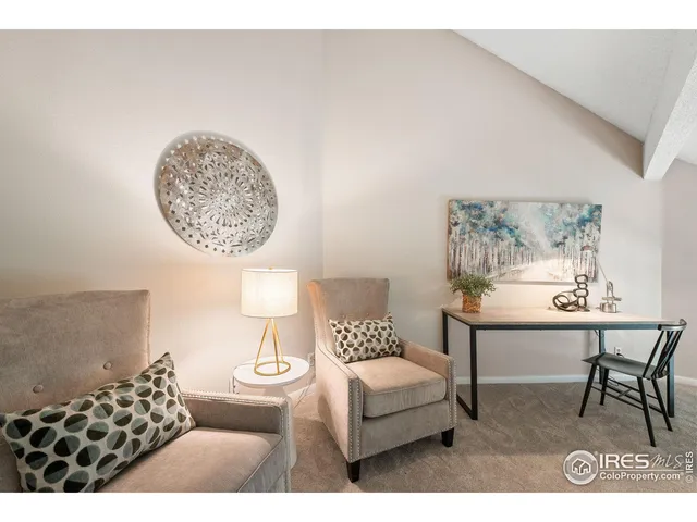 a living room with furniture a rug and a window