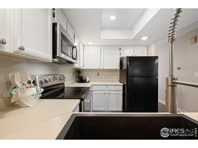 a kitchen with a refrigerator and a sink