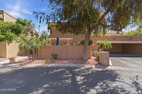 a backyard of a house with table and chairs