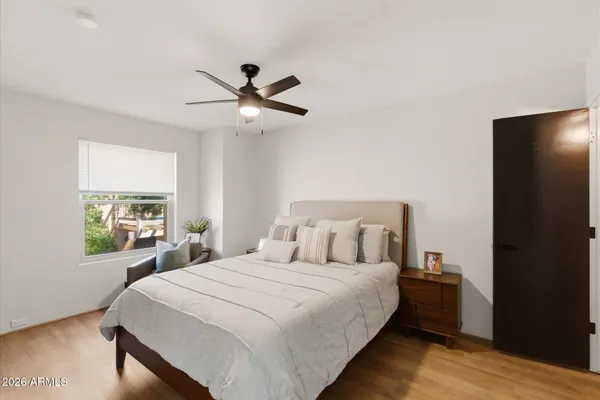 a kitchen with a sink dishwasher a stove and a dining table with wooden floor