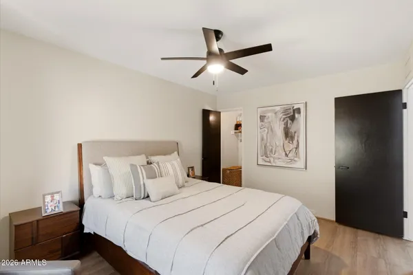 a bedroom with a large bed and a large window