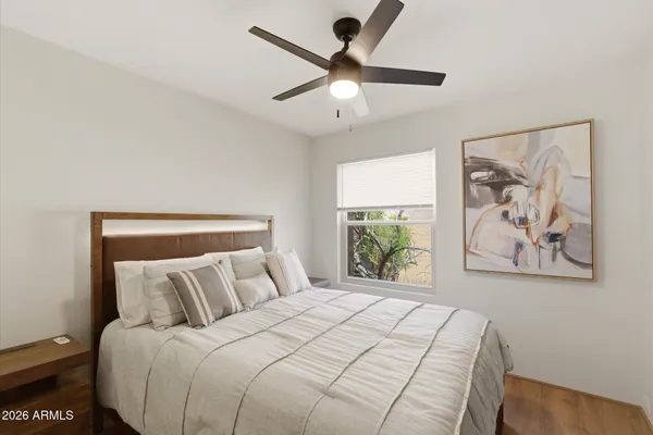 a bedroom with a bed and a painting on the wall