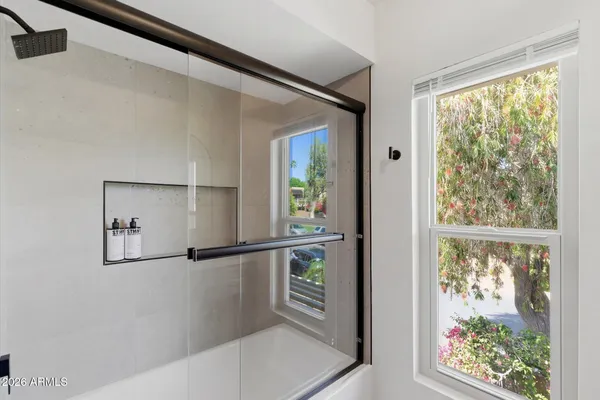 a bathroom with a sink a vanity and a window