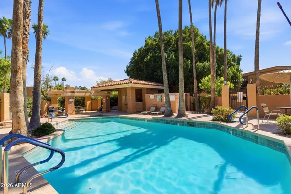 a view of a patio with a table and chairs and potted plants