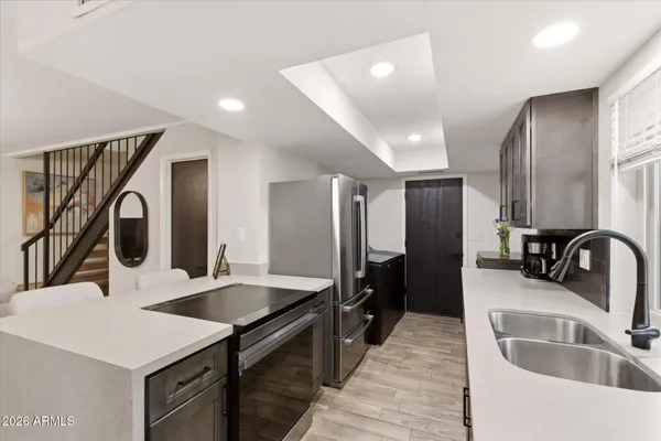 a dining room with furniture a chandelier and window