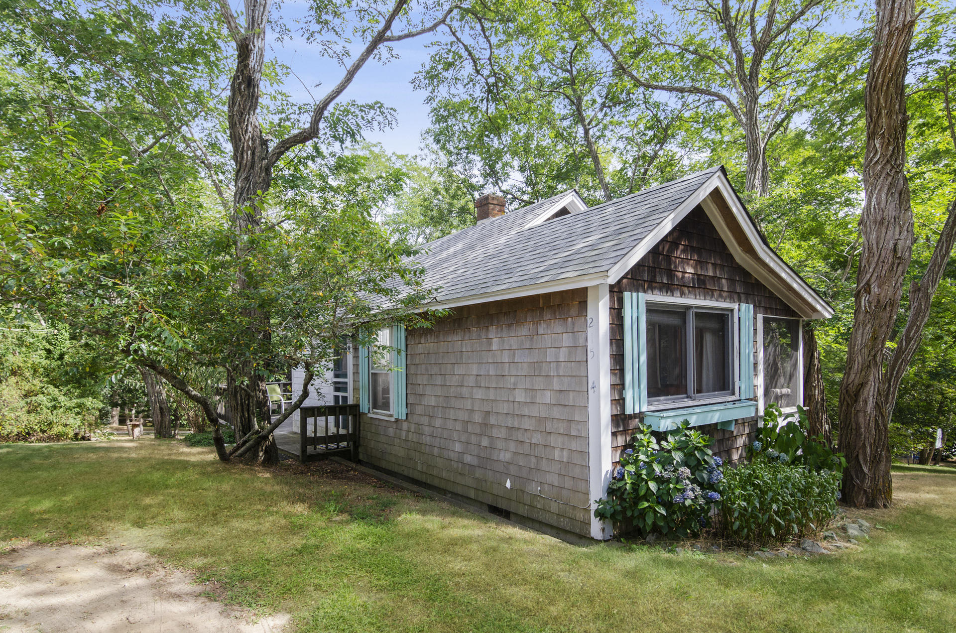 a front view of house with yard and trees