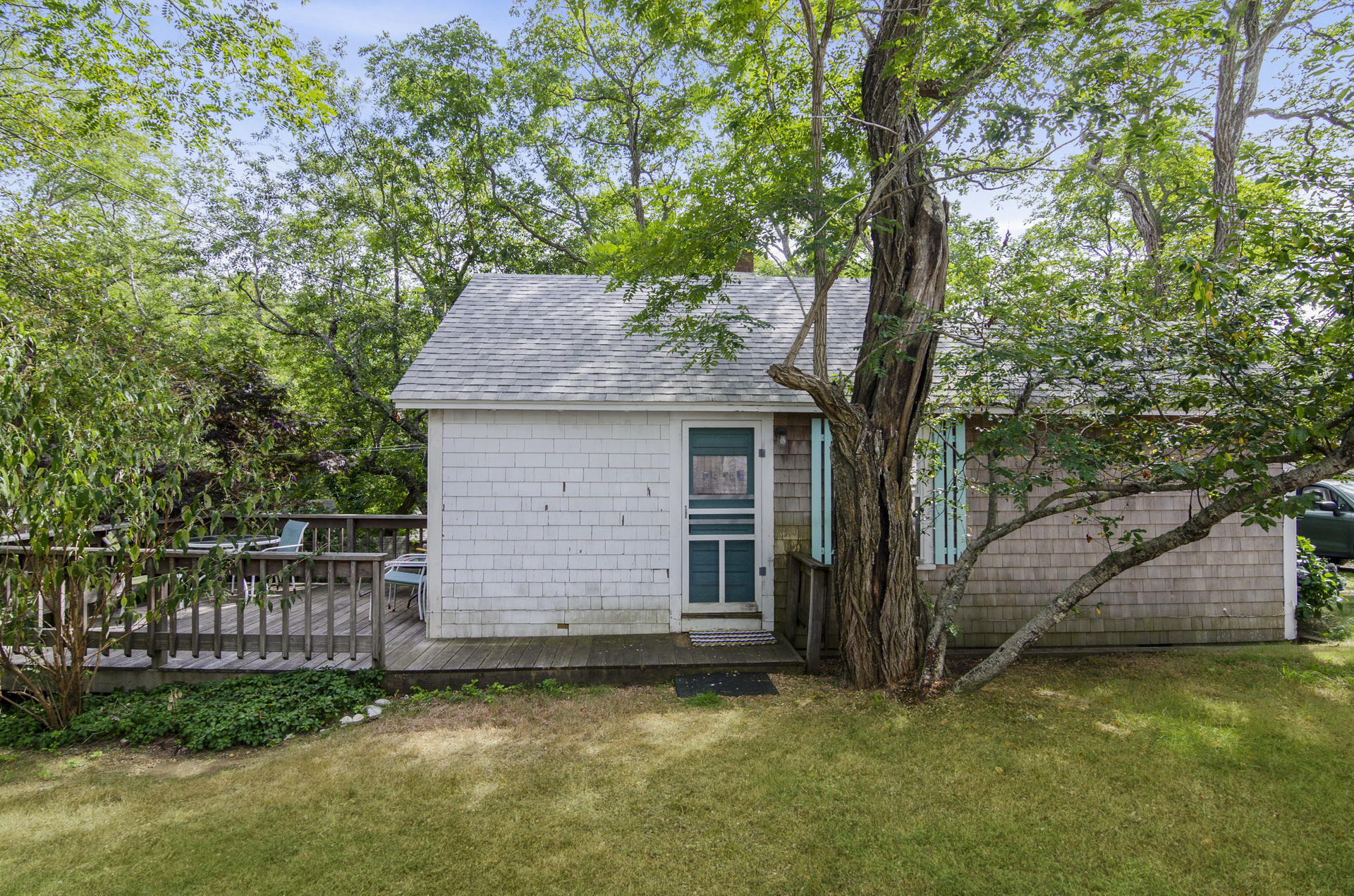215 Pilgrim Spring Road, Unit 4 Wellfleet, MA 02667 - Photo 16 of 28 a view of a house with a small yard and a large tree