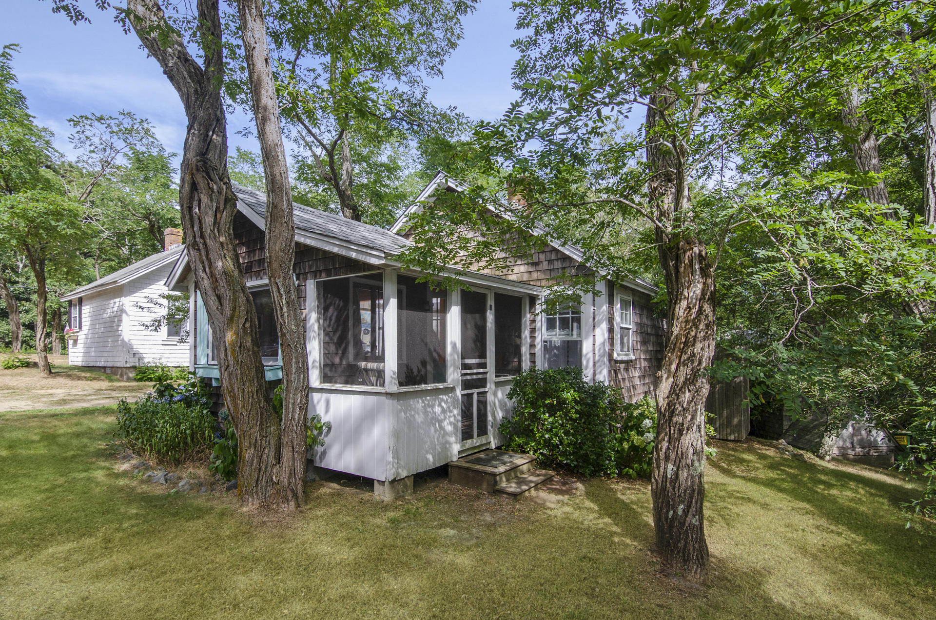 215 Pilgrim Spring Road, Unit 4 Wellfleet, MA 02667 - Photo 3 of 28 front view of a house with a tree in a yard