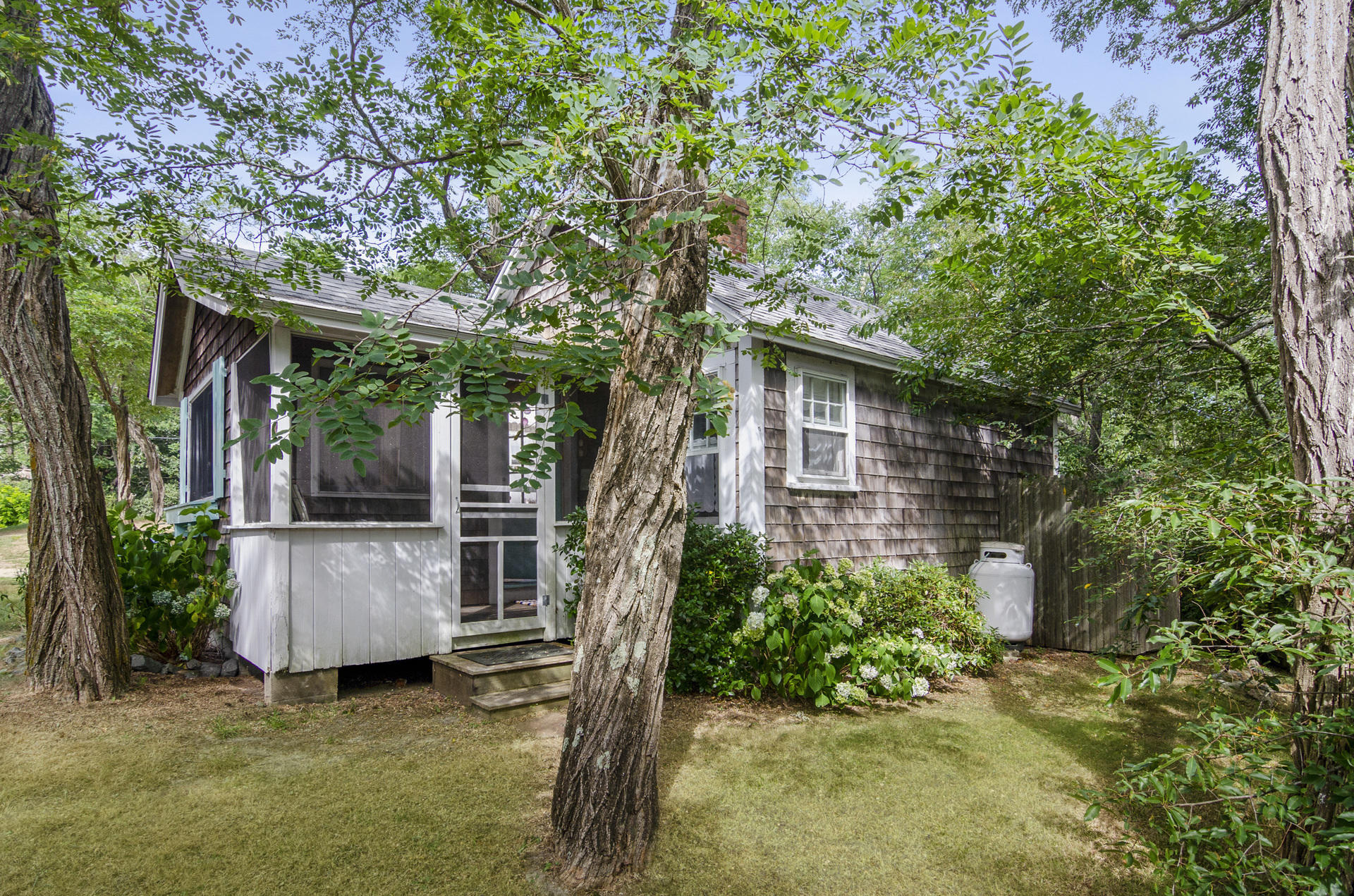 215 Pilgrim Spring Road, Unit 4 Wellfleet, MA 02667 - Photo 4 of 28 a view of a house with backyard and sitting area