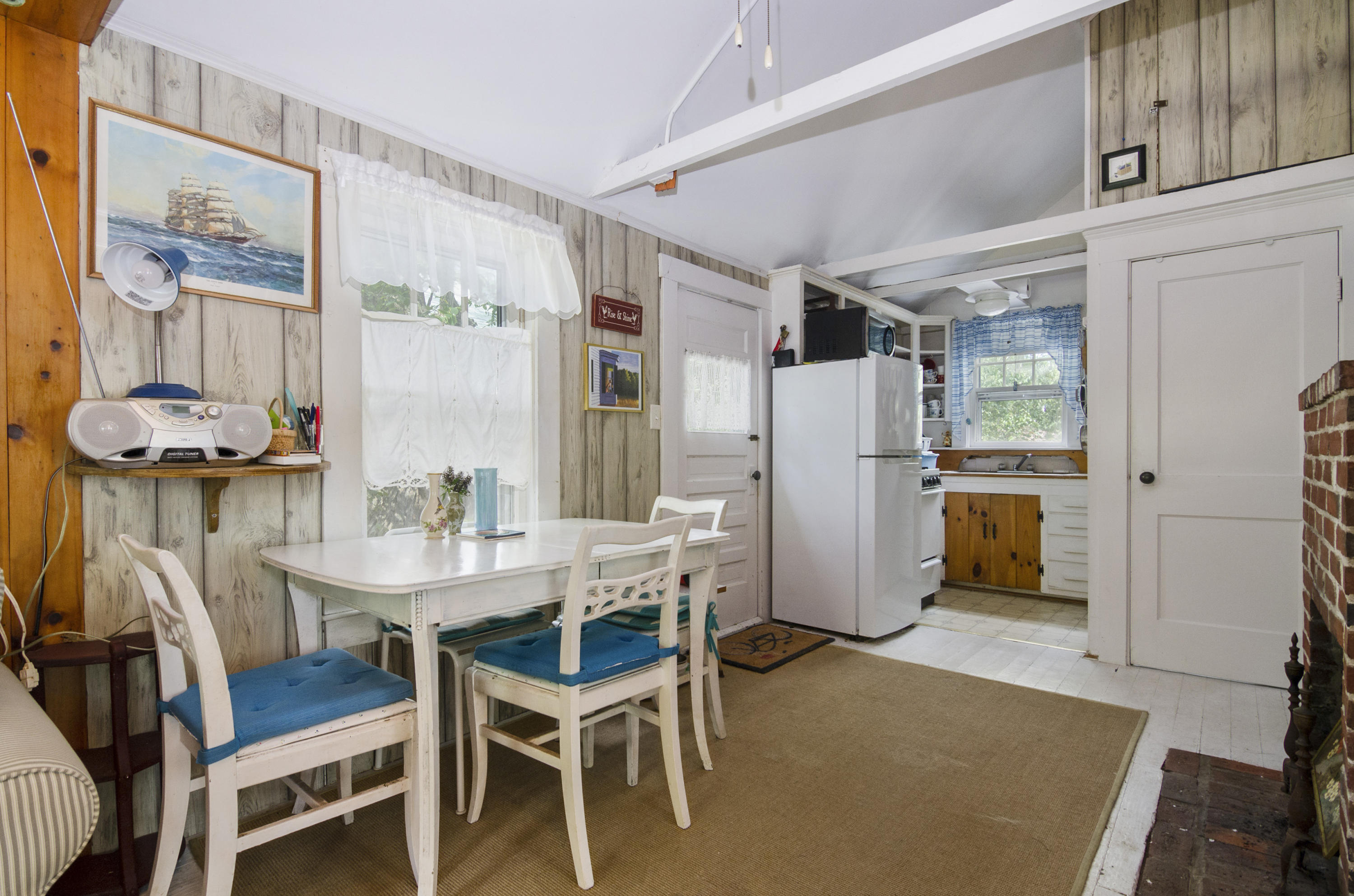 215 Pilgrim Spring Road, Unit 4 Wellfleet, MA 02667 - Photo 6 of 28 a dining room with furniture and wooden floor