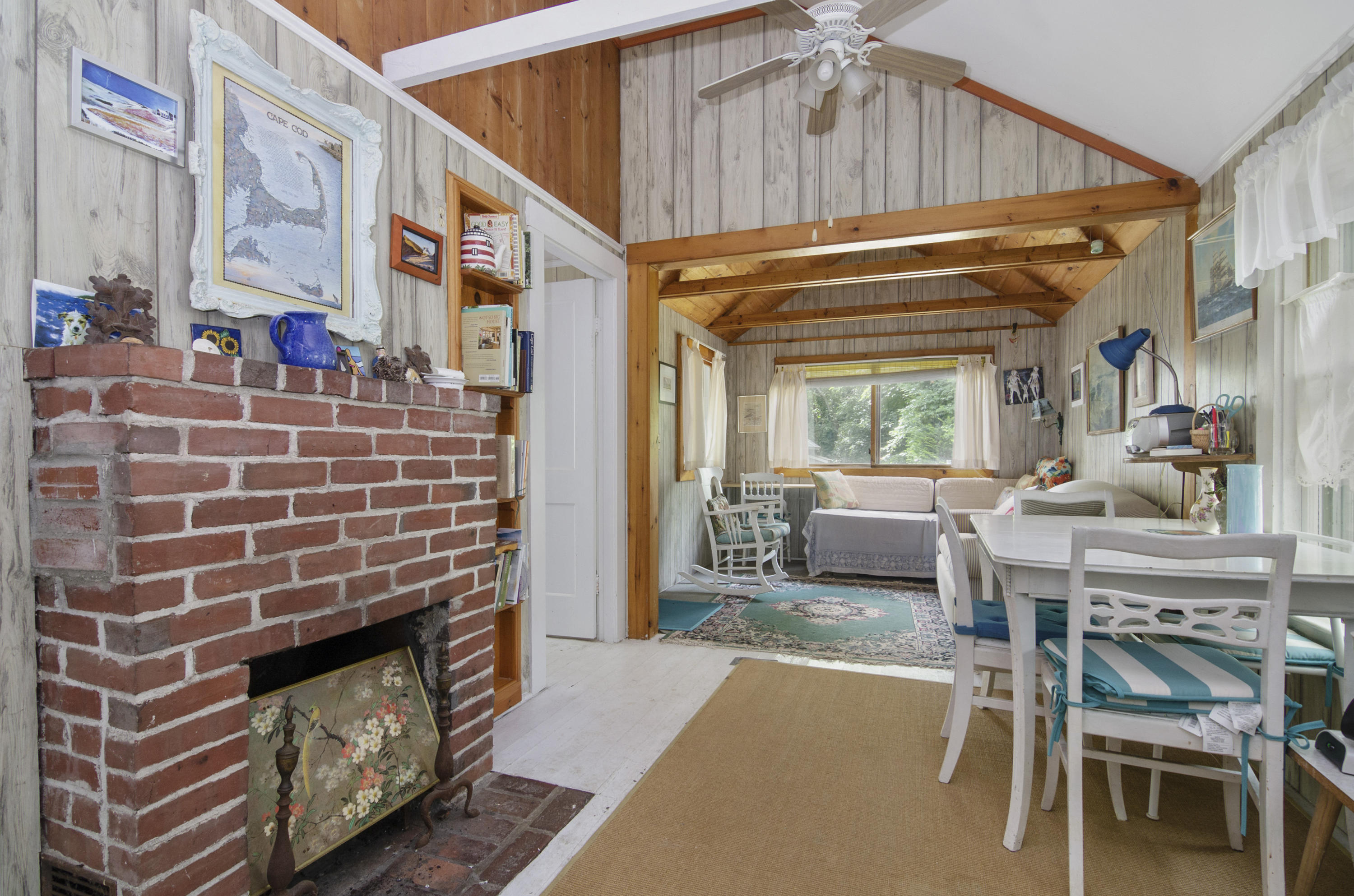 215 Pilgrim Spring Road, Unit 4 Wellfleet, MA 02667 - Photo 9 of 28 a dining room with a table and chairs