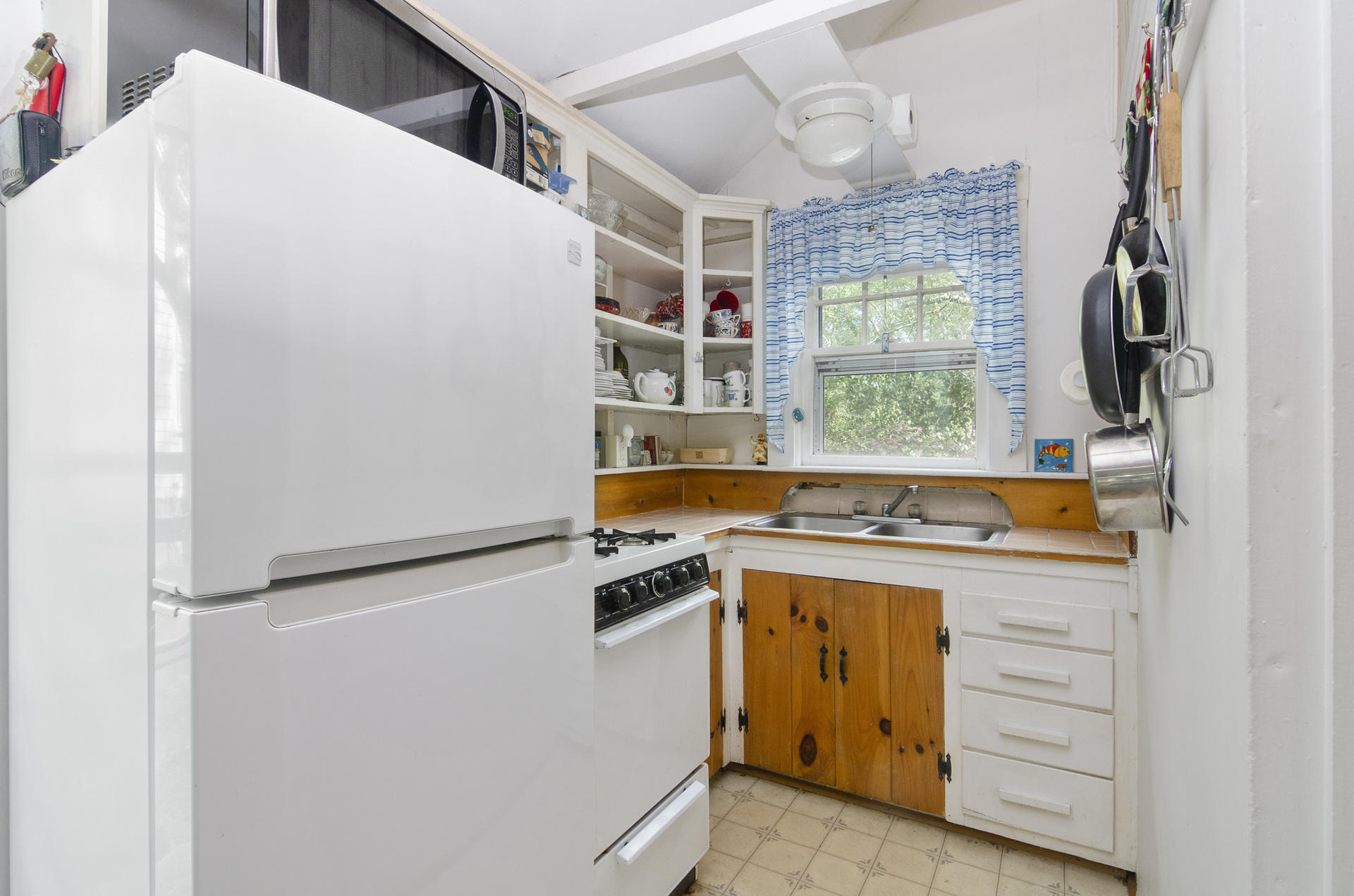 215 Pilgrim Spring Road, Unit 4 Wellfleet, MA 02667 - Photo 10 of 28 a kitchen with a stove and a refrigerator