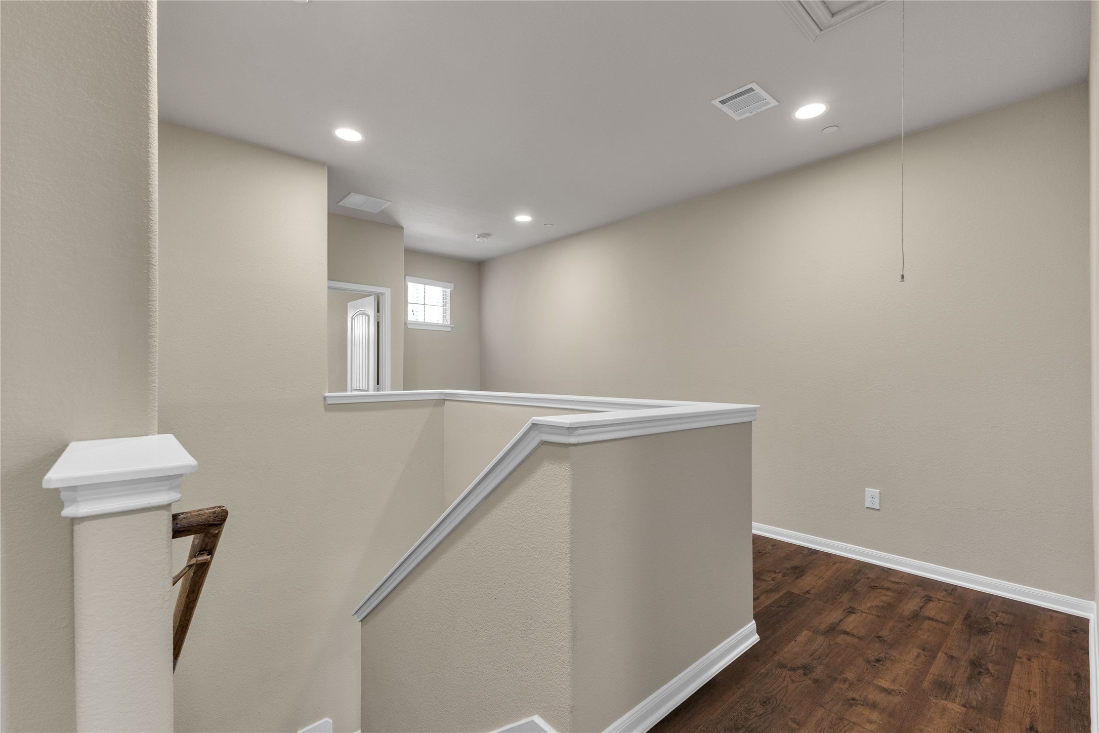 2880 Donnell Drive, Unit 2003 Round Rock, TX 78664 - Photo 25 of 31 Upper-level landing featuring wood-finish flooring, recessed lighting, and a window providing natural light
