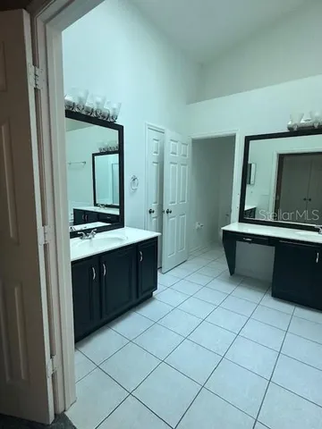 a kitchen with stainless steel appliances a stove top oven a refrigerator and a sink