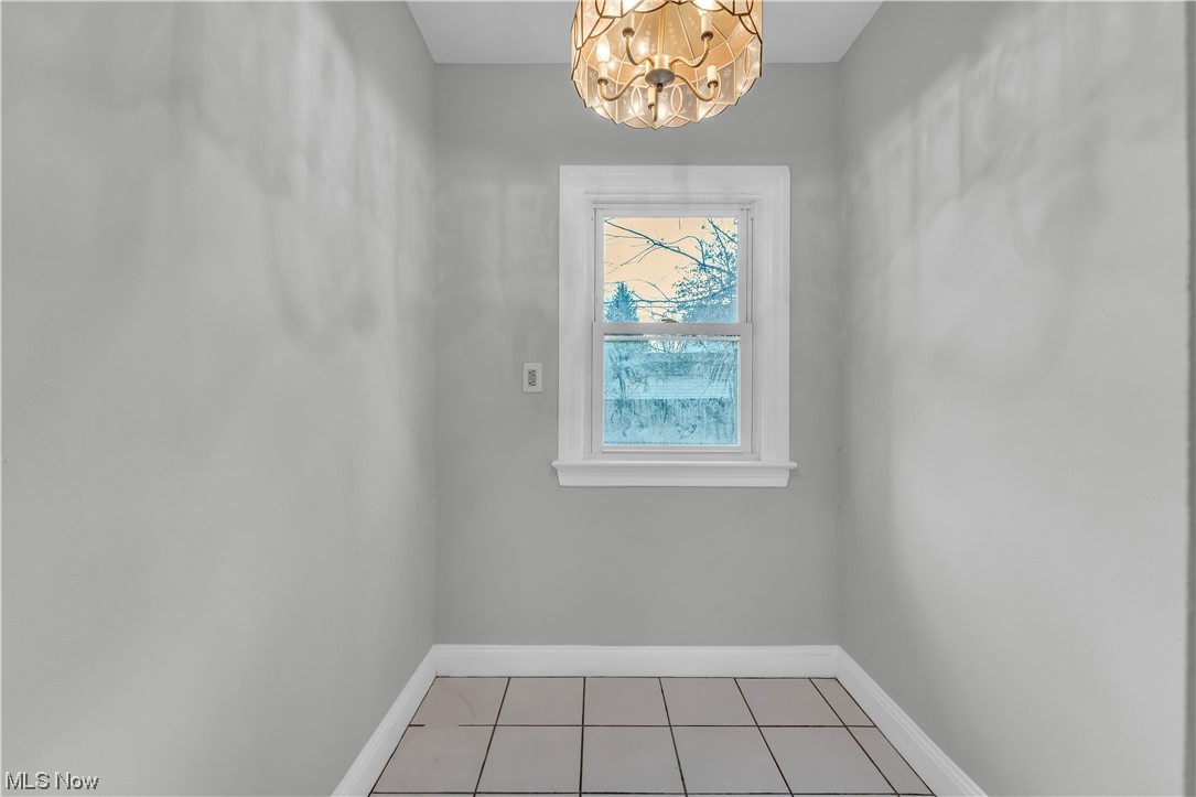 1499 Sherbrook Road South Euclid, OH 44121 - Photo 35 of 41 Tiled spare room with a notable chandelier
