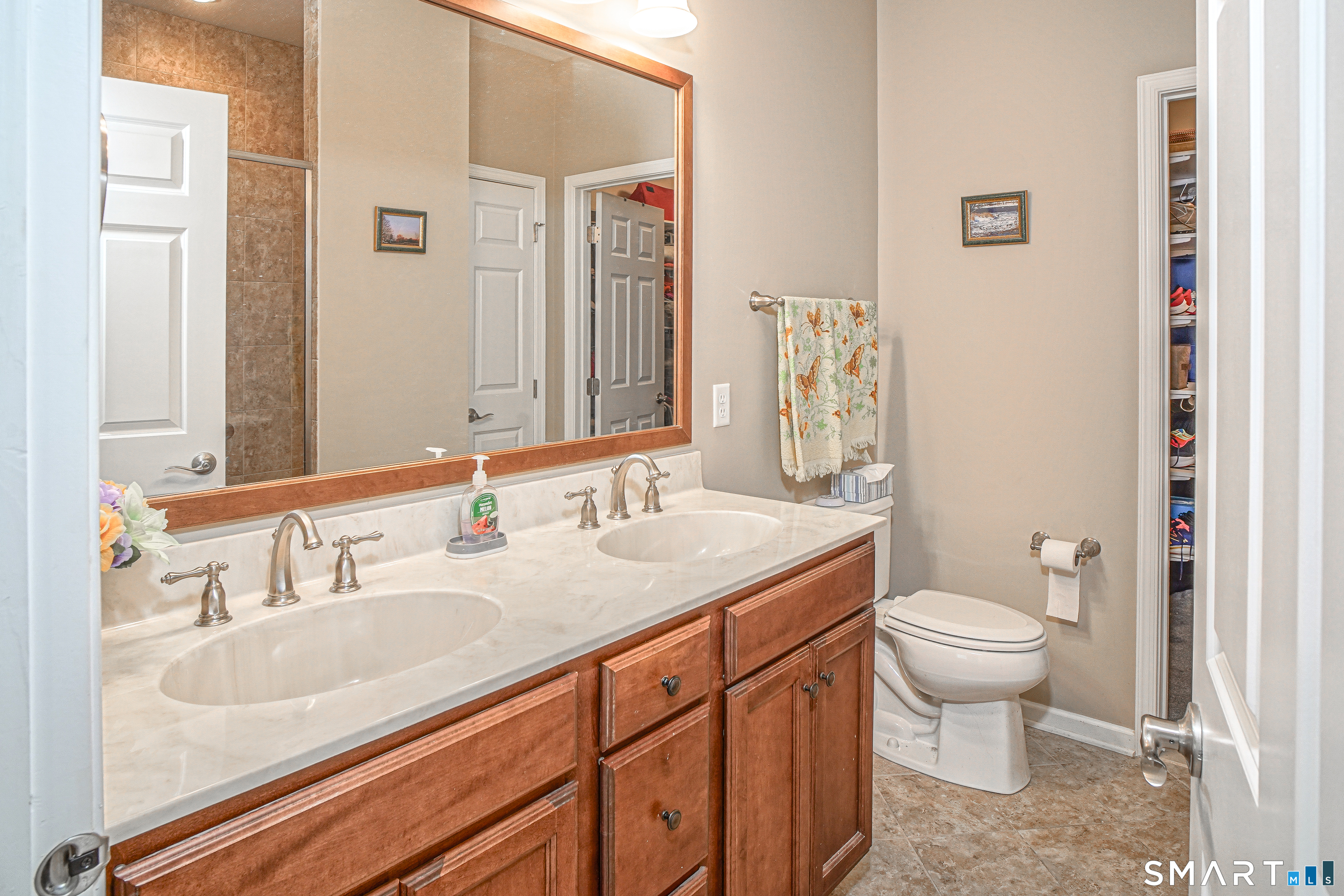 6 Lilac Lane, Unit 6 Prospect, CT 06712 - Photo 17 of 40 Tiled floor, double sinks, glass door shower, and walk-in closet