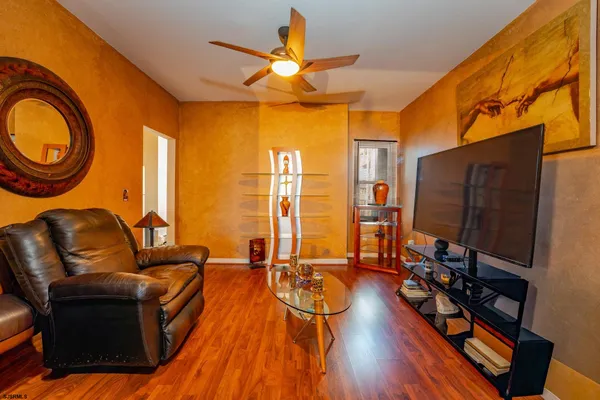 a dining room with furniture and wooden floor