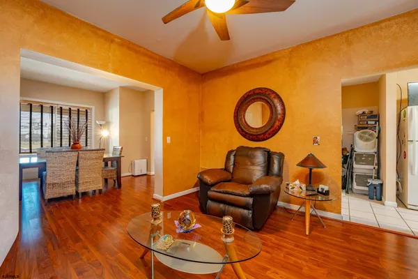 a dining room with furniture and wooden floor