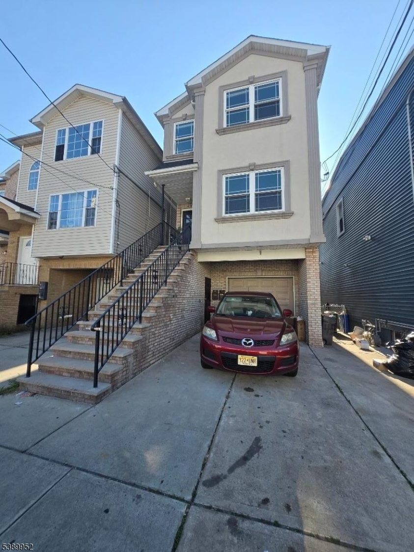 452 Fulton Street, Unit 1 Elizabeth Port, NJ 07206 - Photo 2 of 11 a front view of a house with parking area