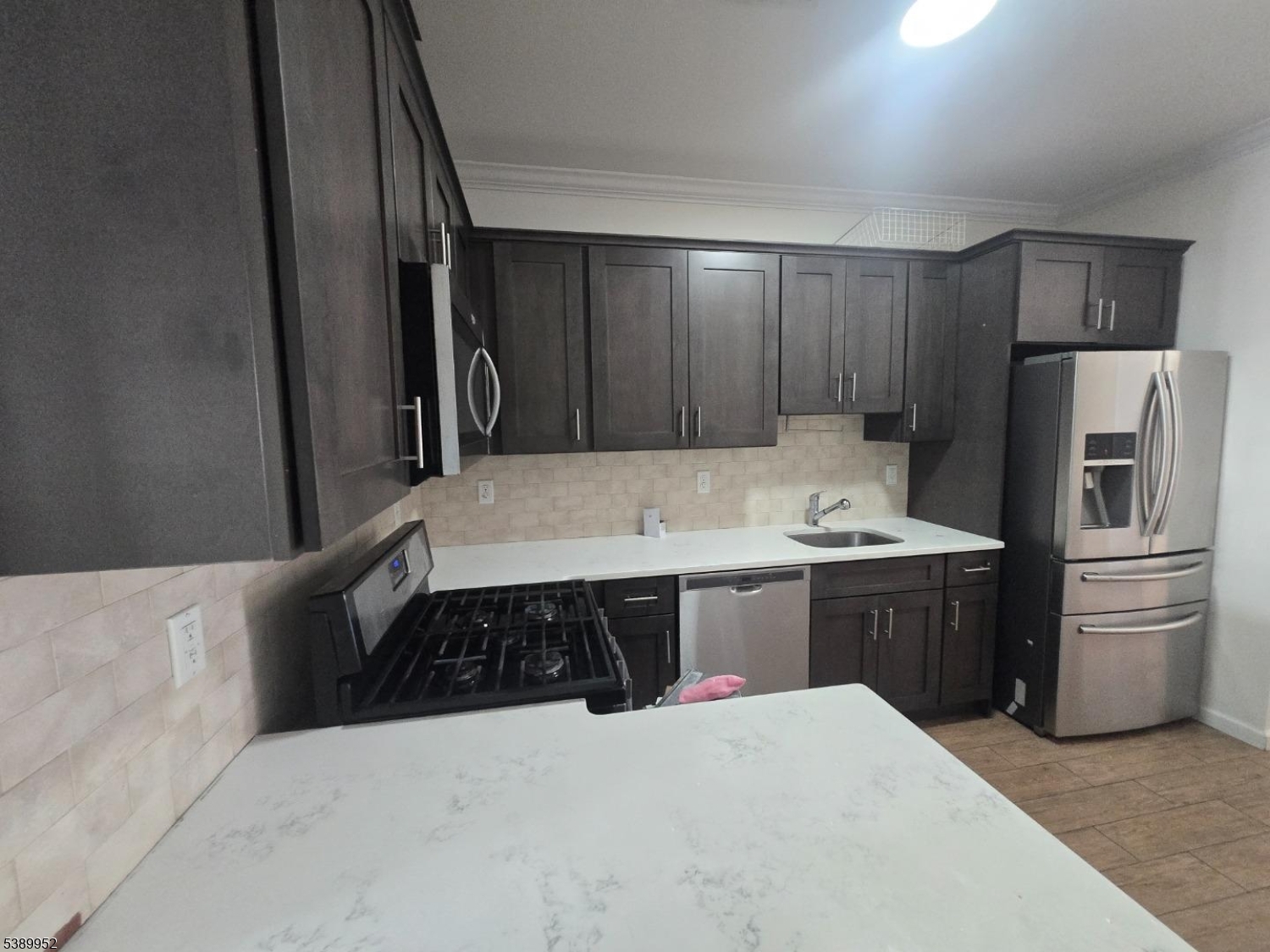 452 Fulton Street, Unit 1 Elizabeth Port, NJ 07206 - Photo 4 of 11 a kitchen with a refrigerator and a sink