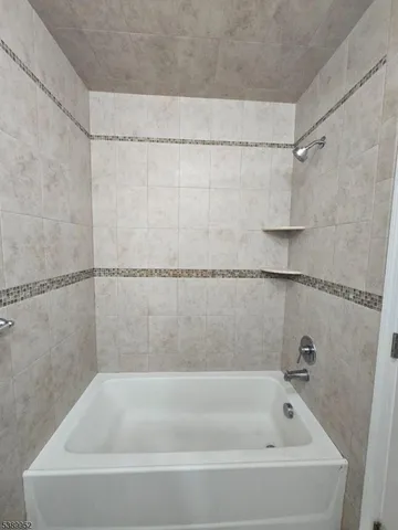 a bathroom with a shower and a bath tub