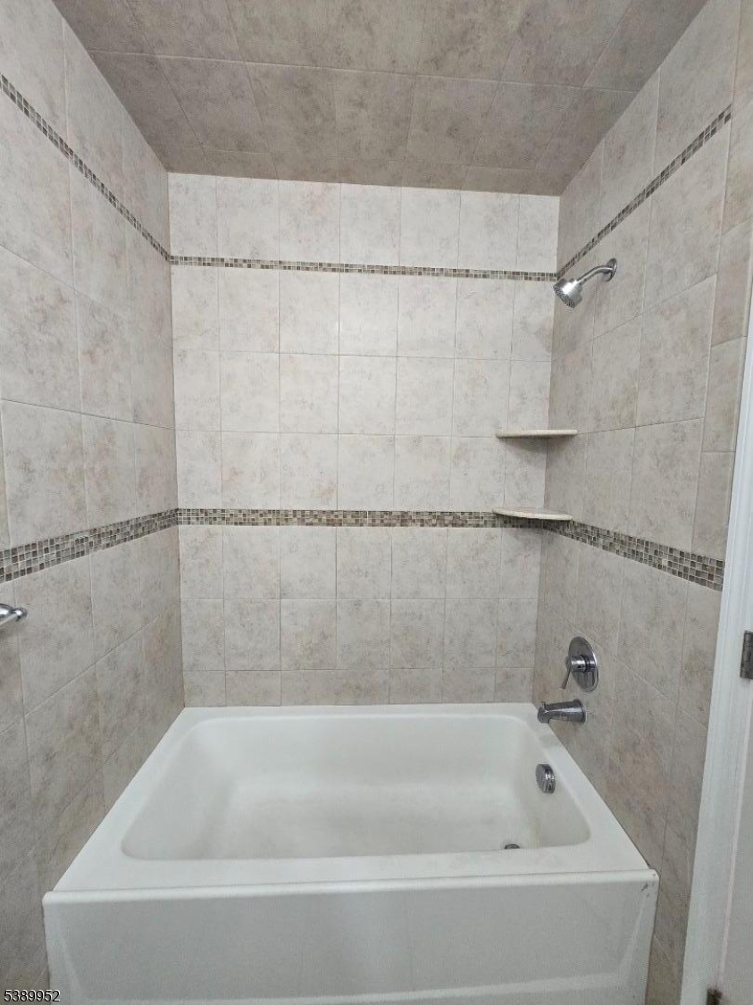 452 Fulton Street, Unit 1 Elizabeth Port, NJ 07206 - Photo 5 of 11 a close view of a bathtub in a bathroom