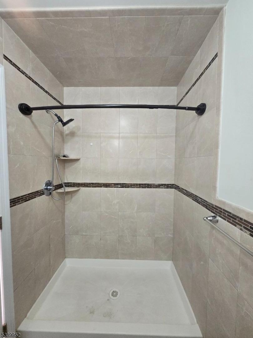 452 Fulton Street, Unit 1 Elizabeth Port, NJ 07206 - Photo 6 of 11 a bathroom with a shower and a bath tub