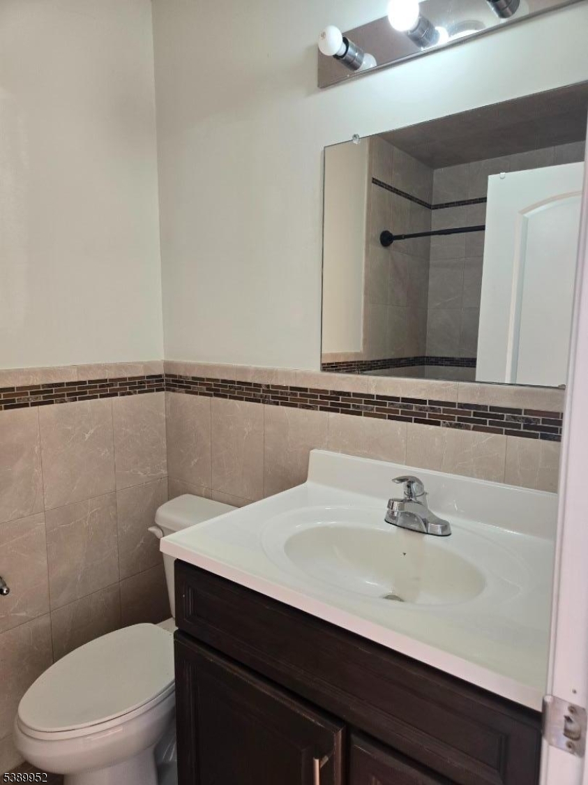 452 Fulton Street, Unit 1 Elizabeth Port, NJ 07206 - Photo 7 of 11 a bathroom with a sink a toilet and mirror