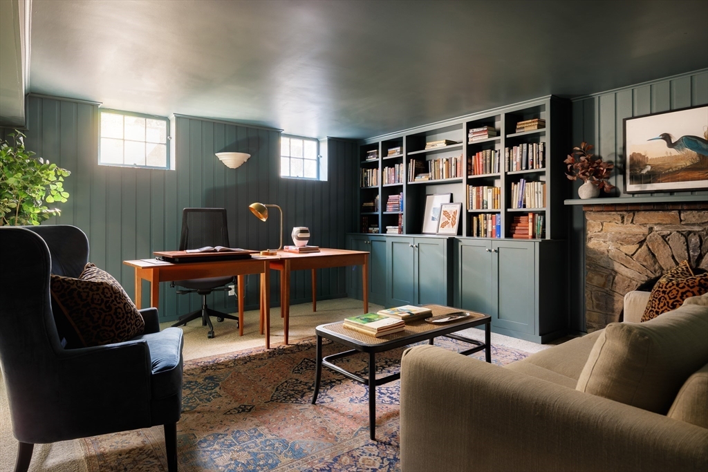 170 Reservoir Road Brookline, MA 02467 - Photo 17 of 20 a living room with furniture a bookshelf and a window
