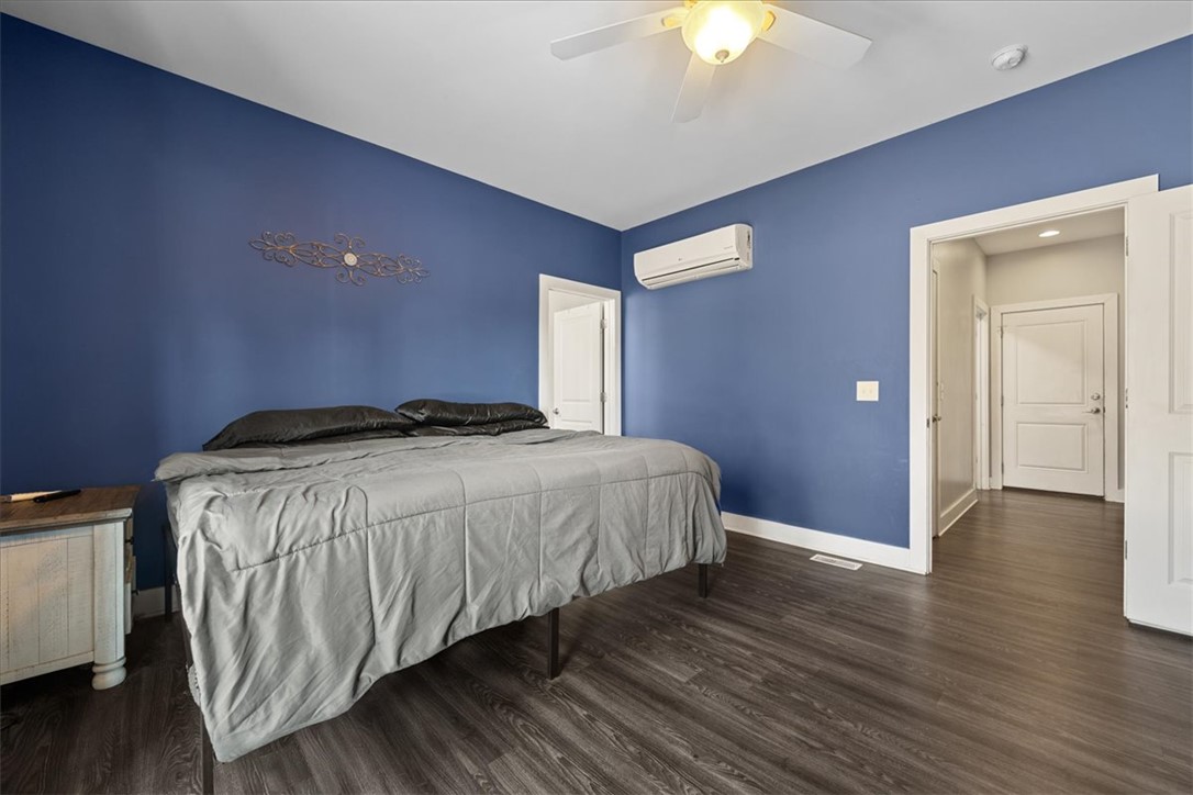 212 Winding Lane Seneca, SC 29672 - Photo 29 of 48 This spacious bedroom features warm hardwood floors and abundant natural light.