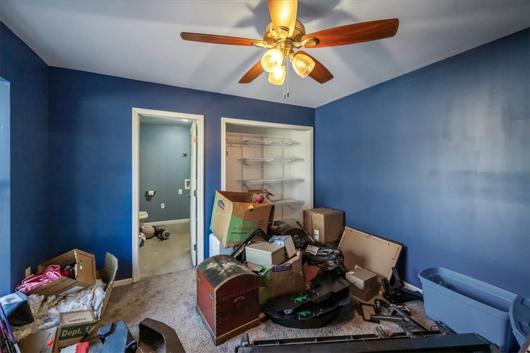 212 Winding Lane Seneca, SC 29672 - Photo 41 of 48 This cozy bedroom features a ceiling fan, plush carpet, and a convenient closet with shelving.