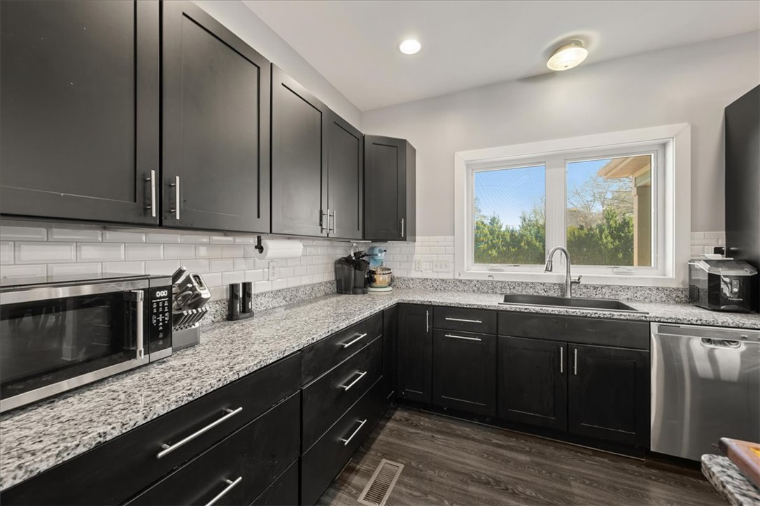 212 Winding Lane Seneca, SC 29672 - Photo 5 of 48 This modern kitchen features sleek cabinetry, granite countertops, and stylish flooring.