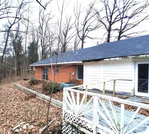 a view of house with backyard and trees