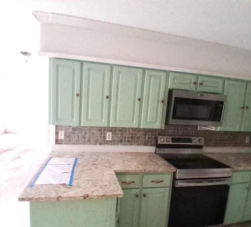 a kitchen with a sink and a microwave