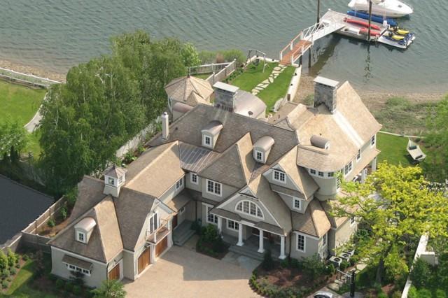 an aerial view of a house with a yard and balcony