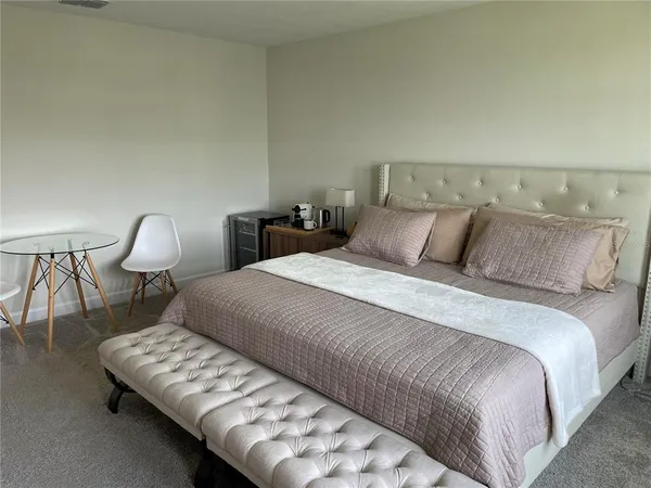 a bedroom with a bed window and lamp