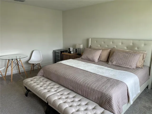 a bedroom with a bed window and lamp