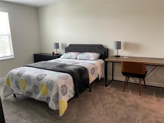 a bedroom with a bed and a window