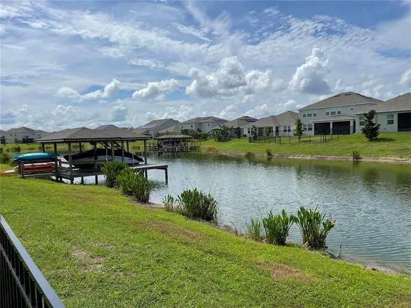 a view of a lake with houses in the back