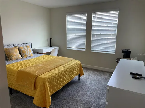 a bedroom with a bed and window