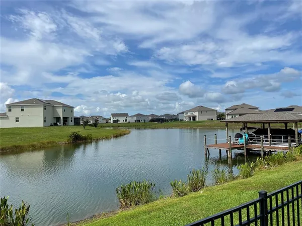a view of a lake with houses in the back