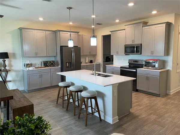 a kitchen with kitchen island a sink table and chairs