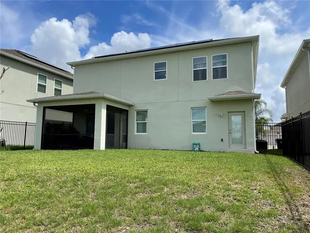 a view of a house with a yard and a garage