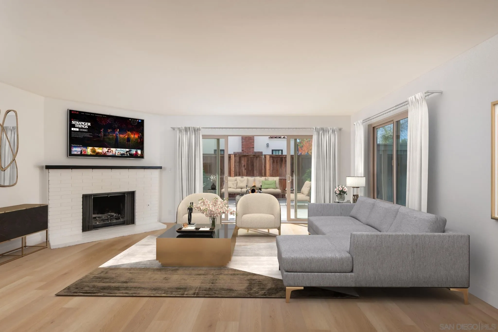 a living room with furniture a flat screen tv and a fireplace