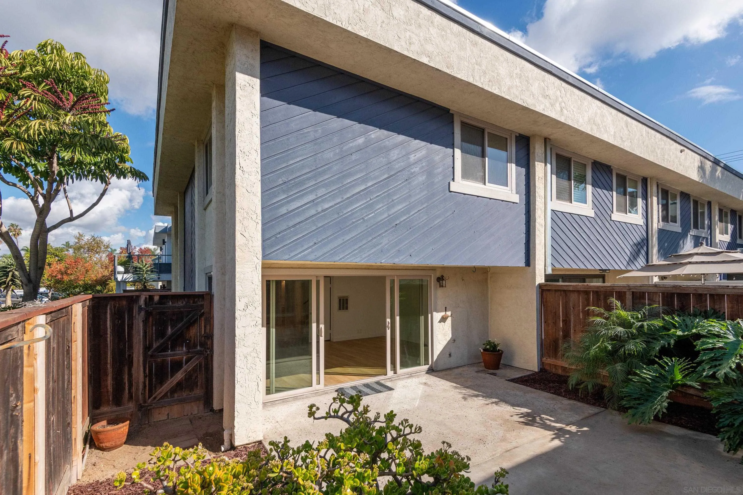 441 D Avenue Coronado, CA 92118 - Photo 15 of 24 a view of a house with a small yard plants and large tree